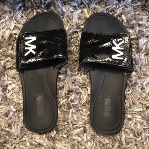 Cute Black MK sandals with white letters.